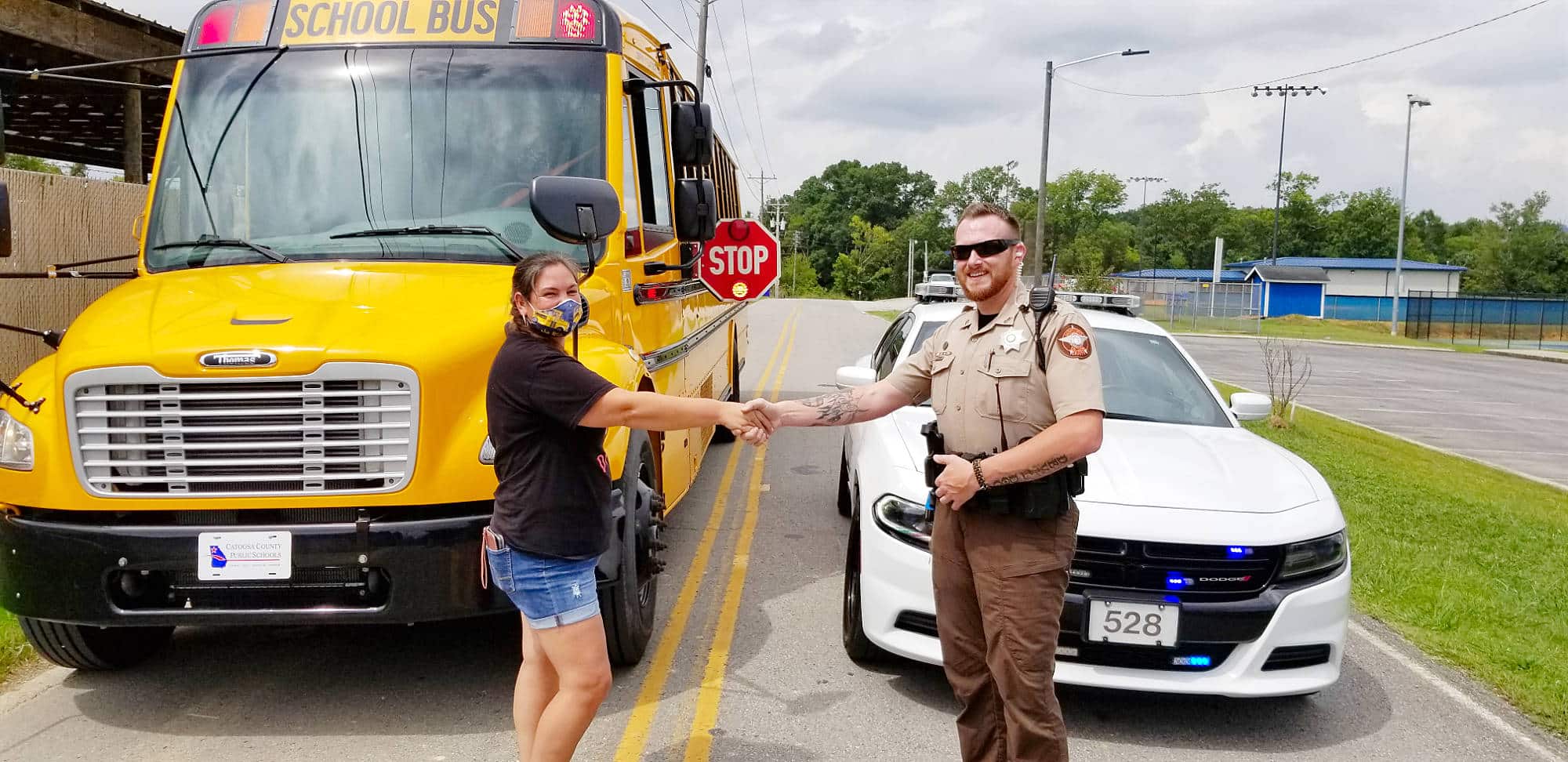 student and officer shaking hands